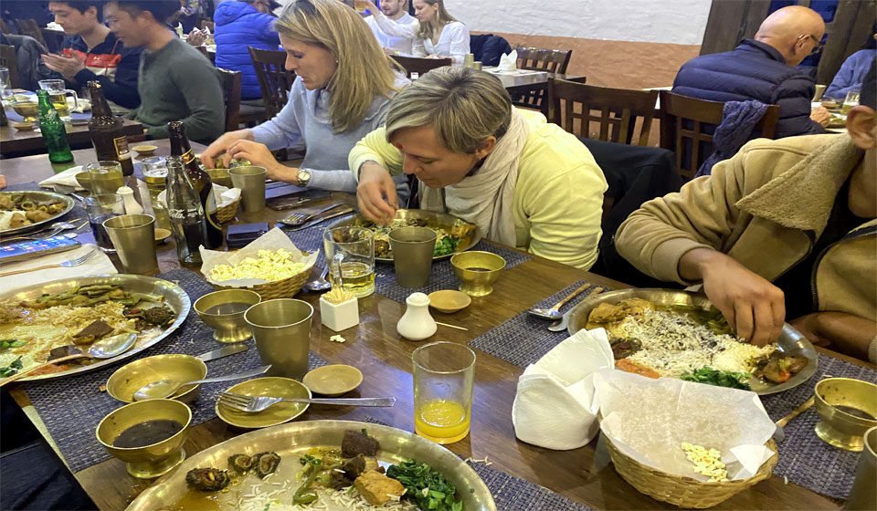 Tourist Enjoying Nepalese Dinner in Nepalese Style